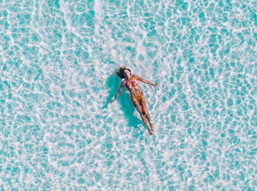 Woman swimming in crystal clear water